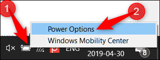 Right click the battery icon in the system tray, then click Power Options